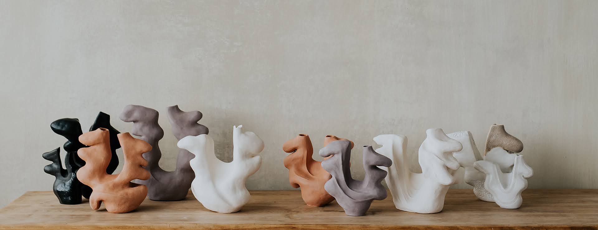 Black, white and red ceramic vessel silhouettes with wavy forms