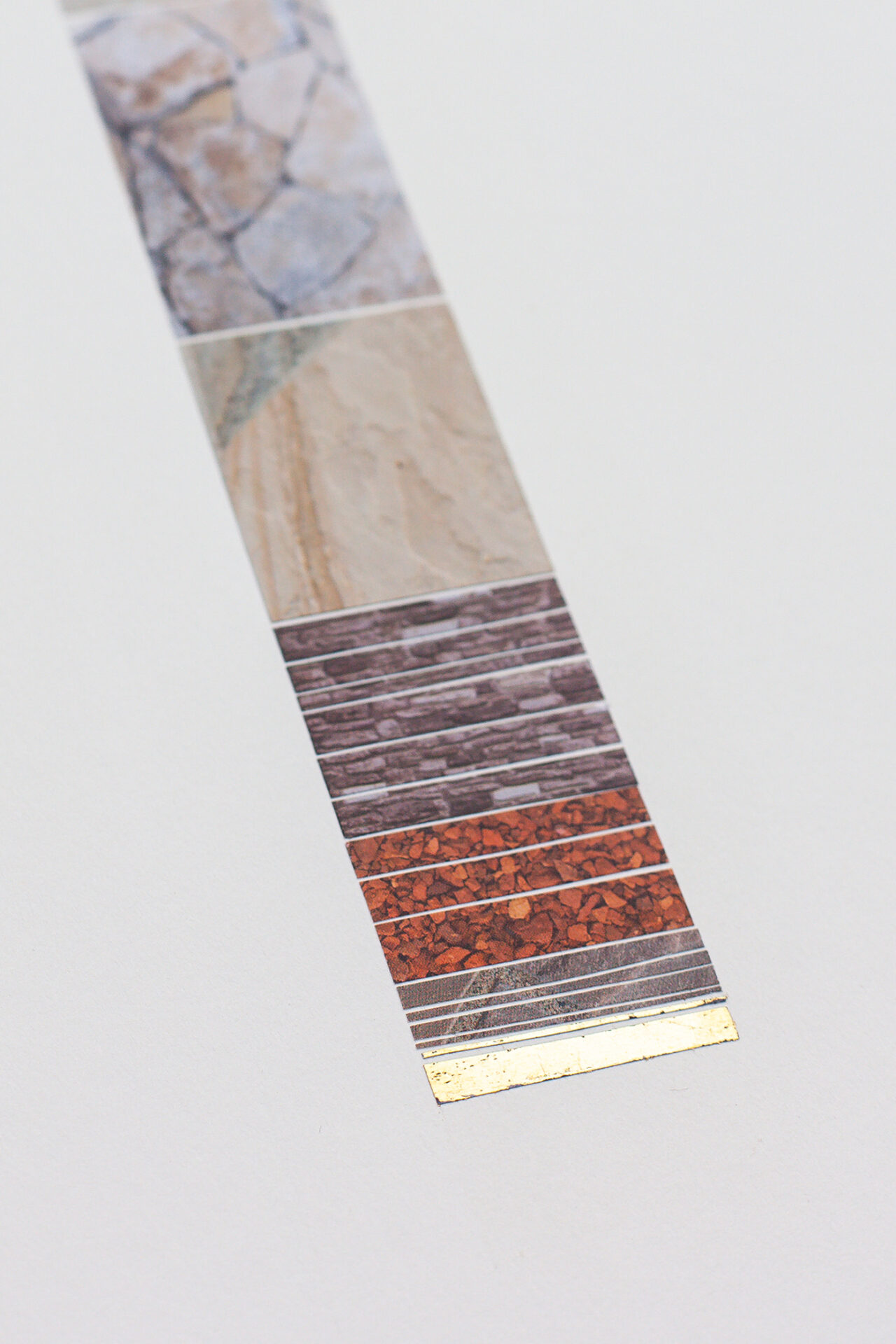 A vertical strip showcasing a variety of textured geologic materials and a metallic gold edge.