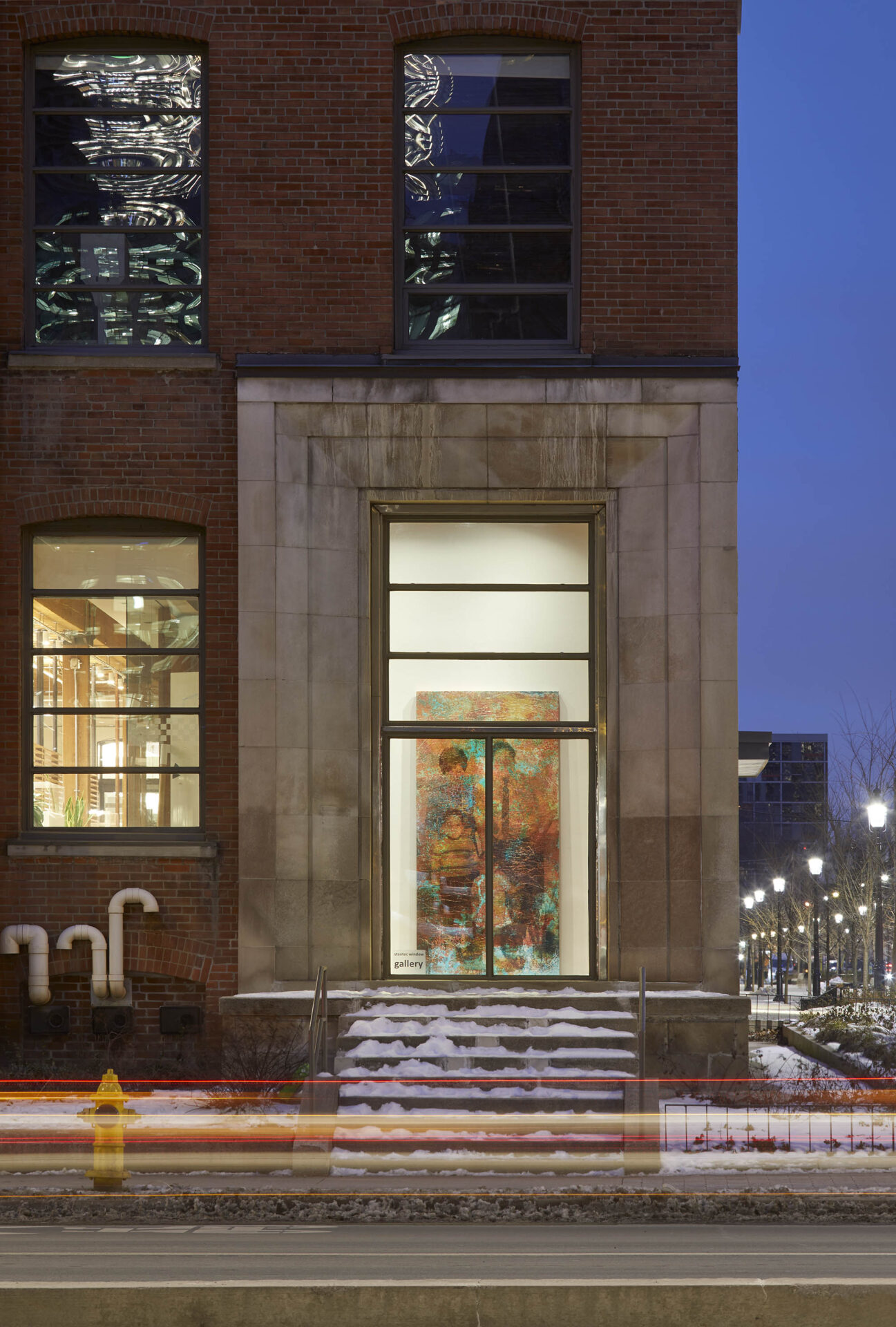 Street view of window gallery featuring an enlarged family photograph printed onto a corroded copper plate.