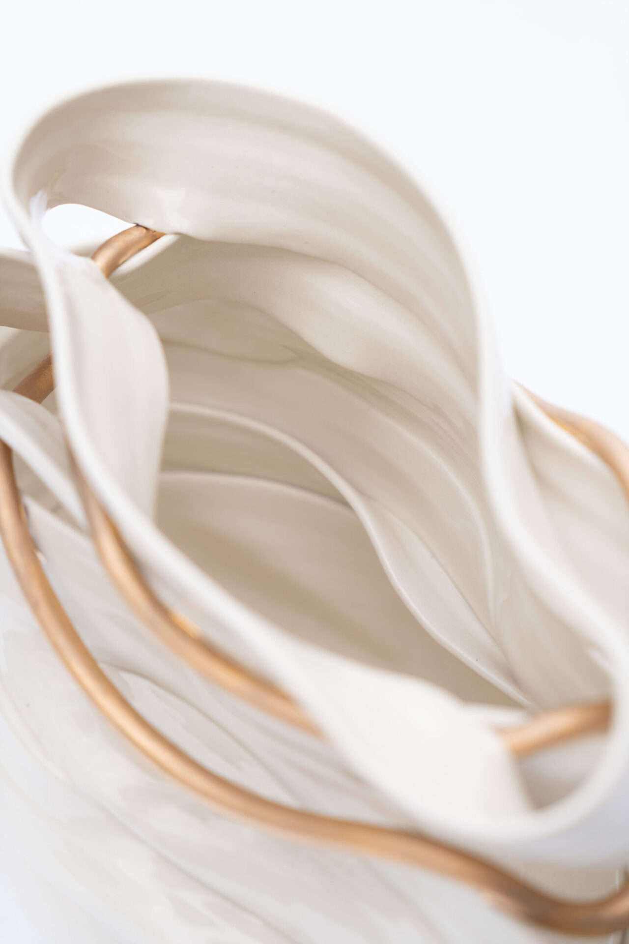 Interior of White ceramic ribbon vase with gold detail