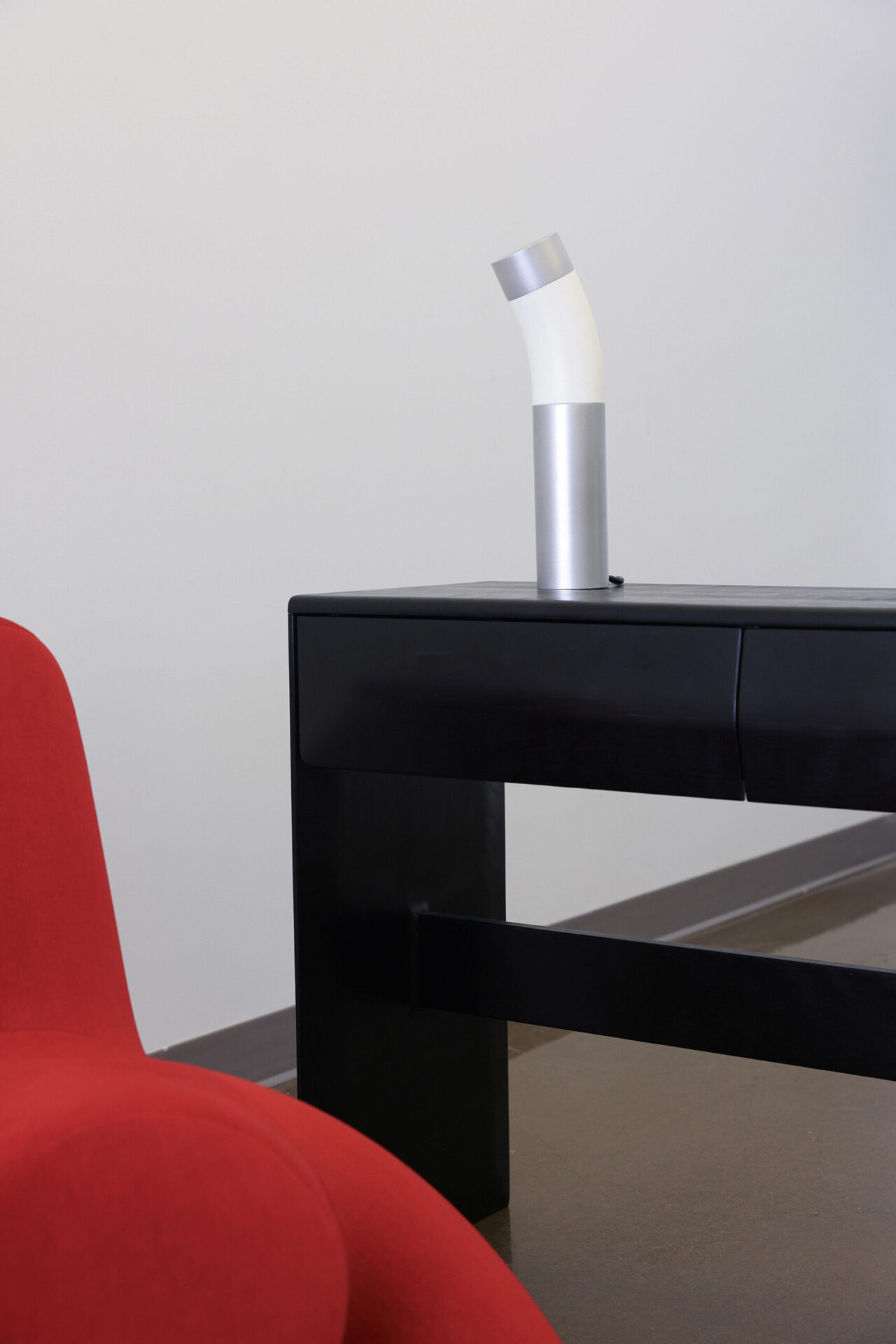 red chair with a black desk behind