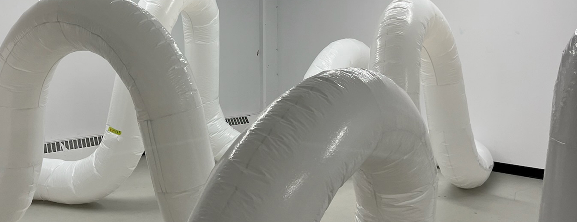 Image of inflatable tubes in a white industrial interior