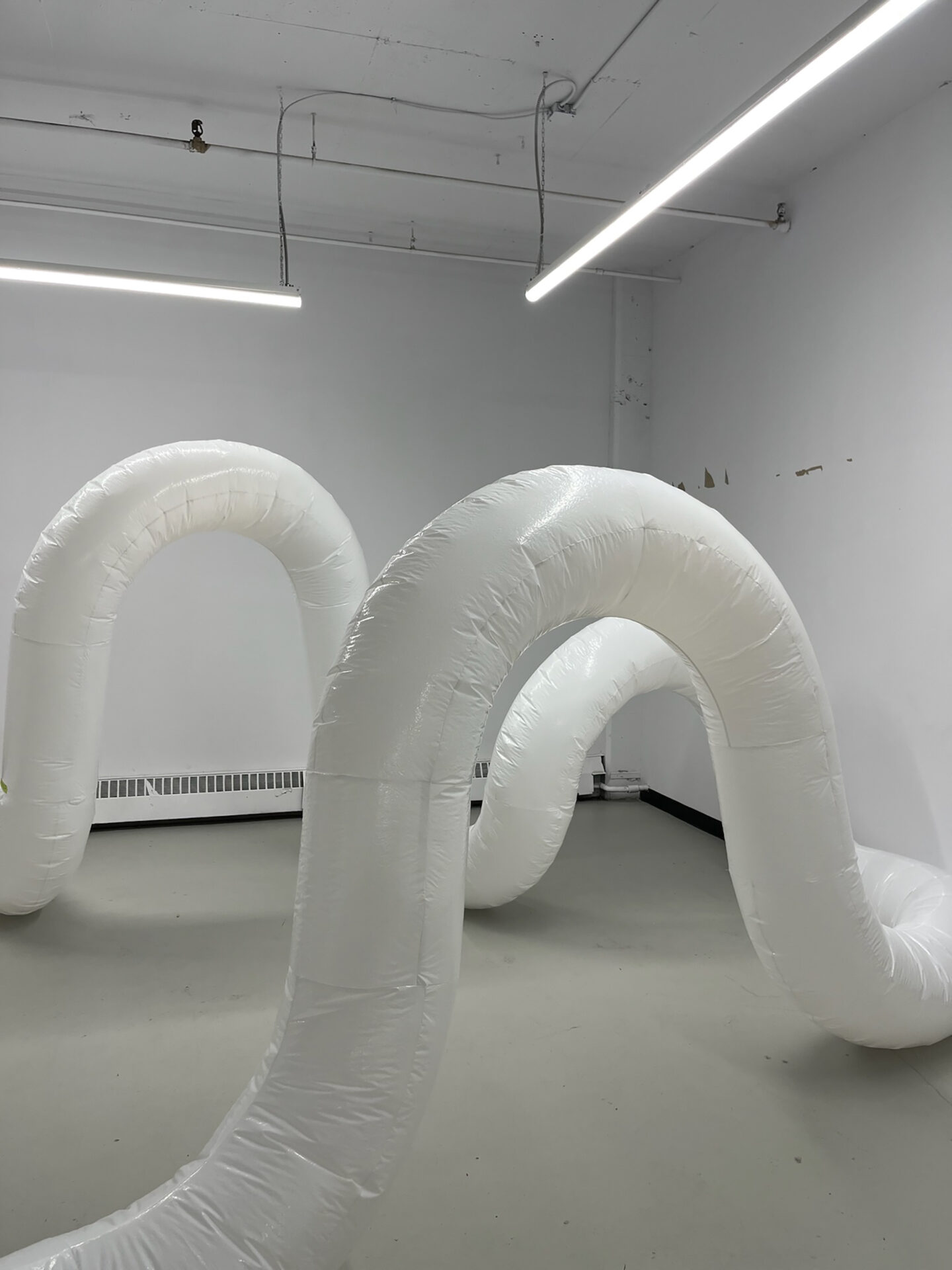 Inflatable plastic tubes in a white industrial interior