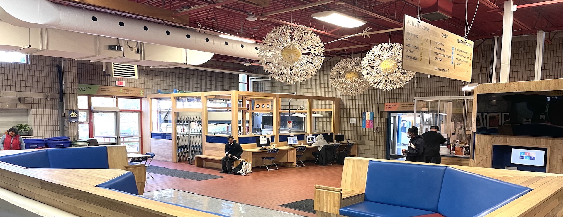 View of Scadding Court Lobby facing north showing Dandelion sculptures, seating, computer stations  and aquaponics area