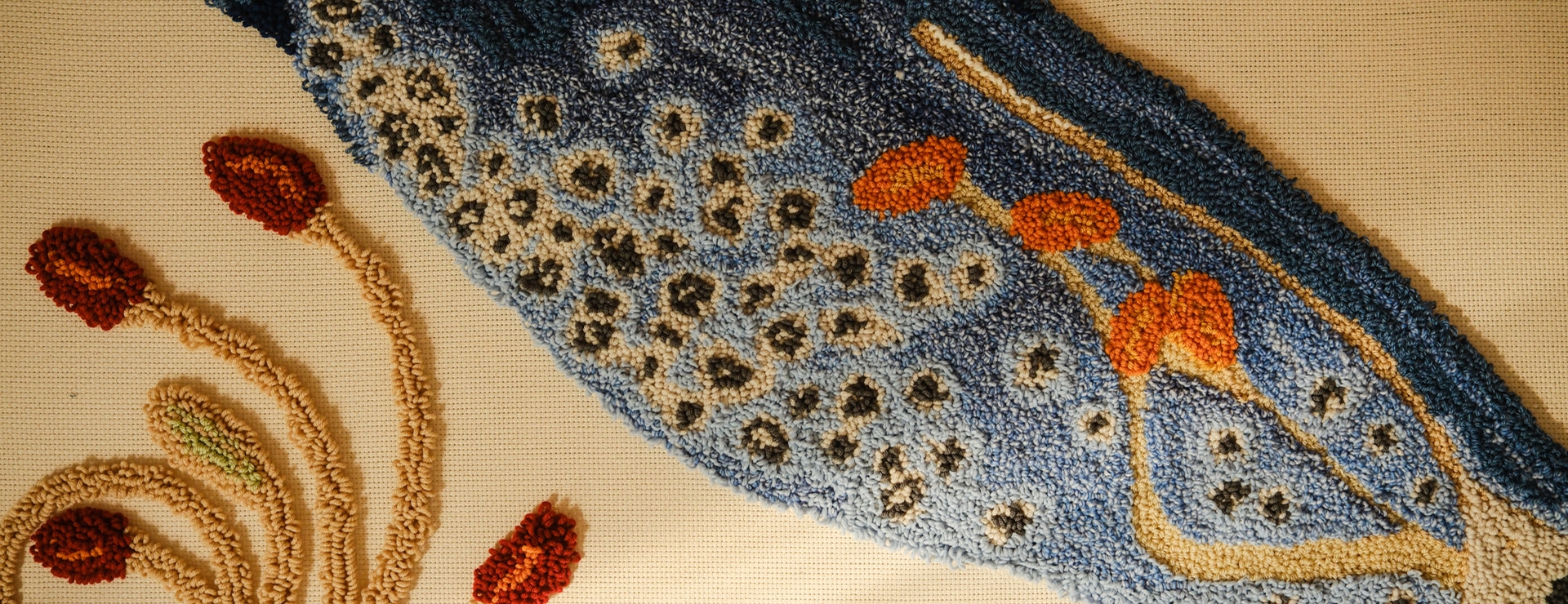 Close-up shot of a punch needle of a blue foxglove flower. 