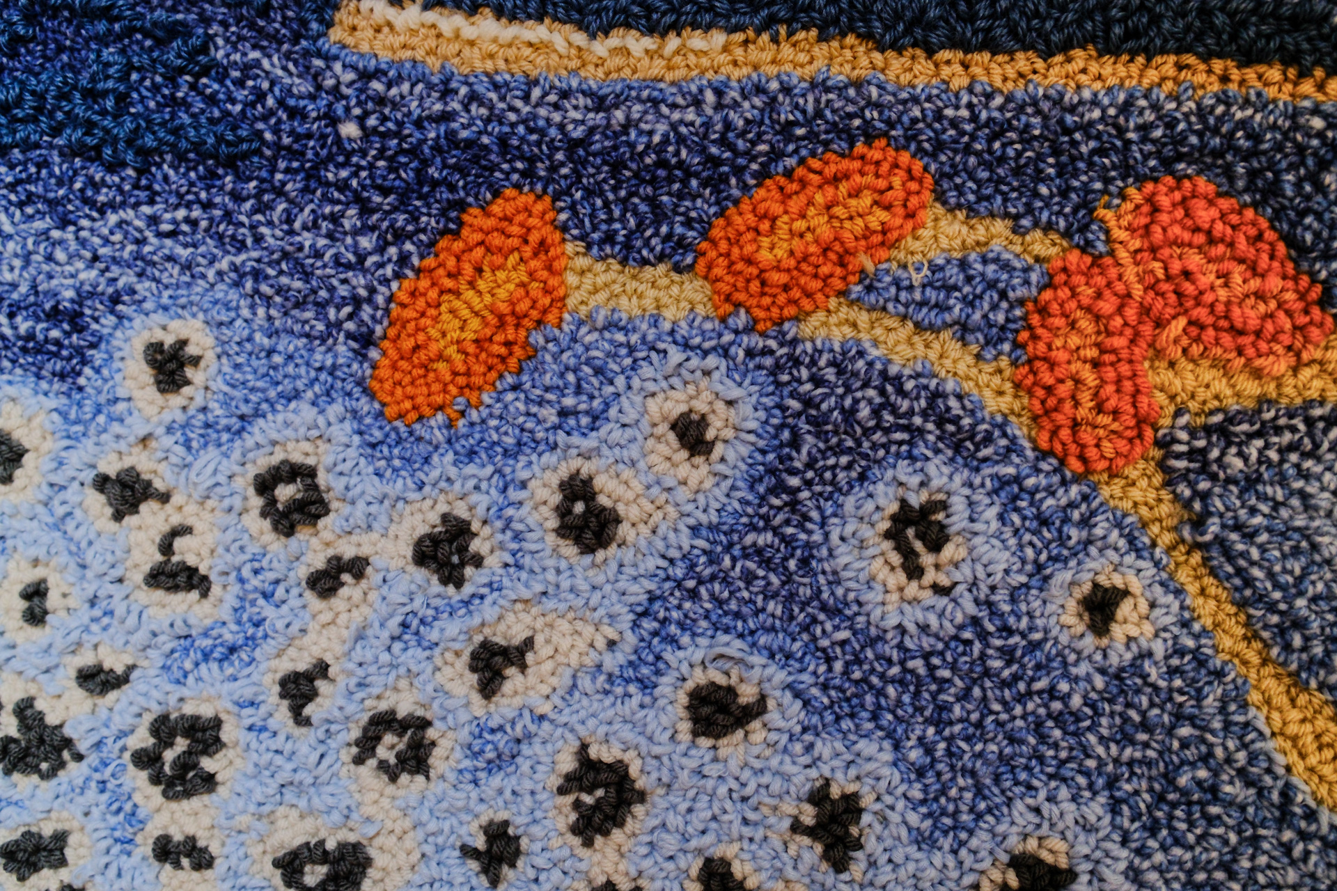 Close-up shot of a punch needle of a blue foxglove flower. 