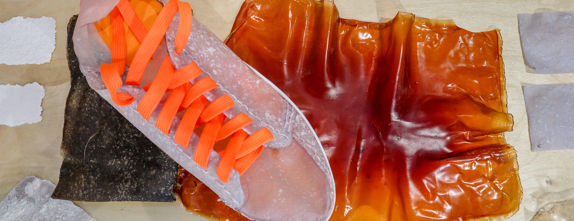 Sneaker made of biomaterials with samples laid out on a surface