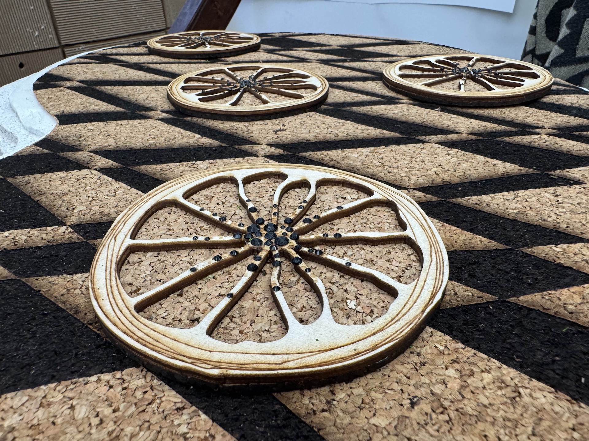 Close up image of coasters made of wood and cork to resemble an orange slice.