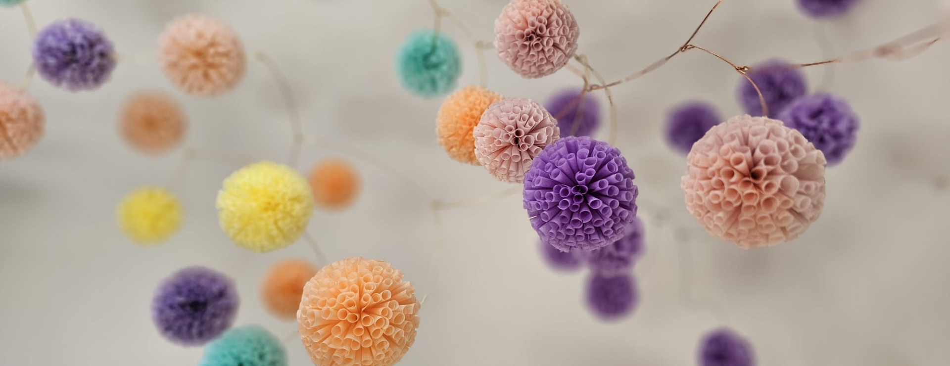 a photo of colourful paper mobiles