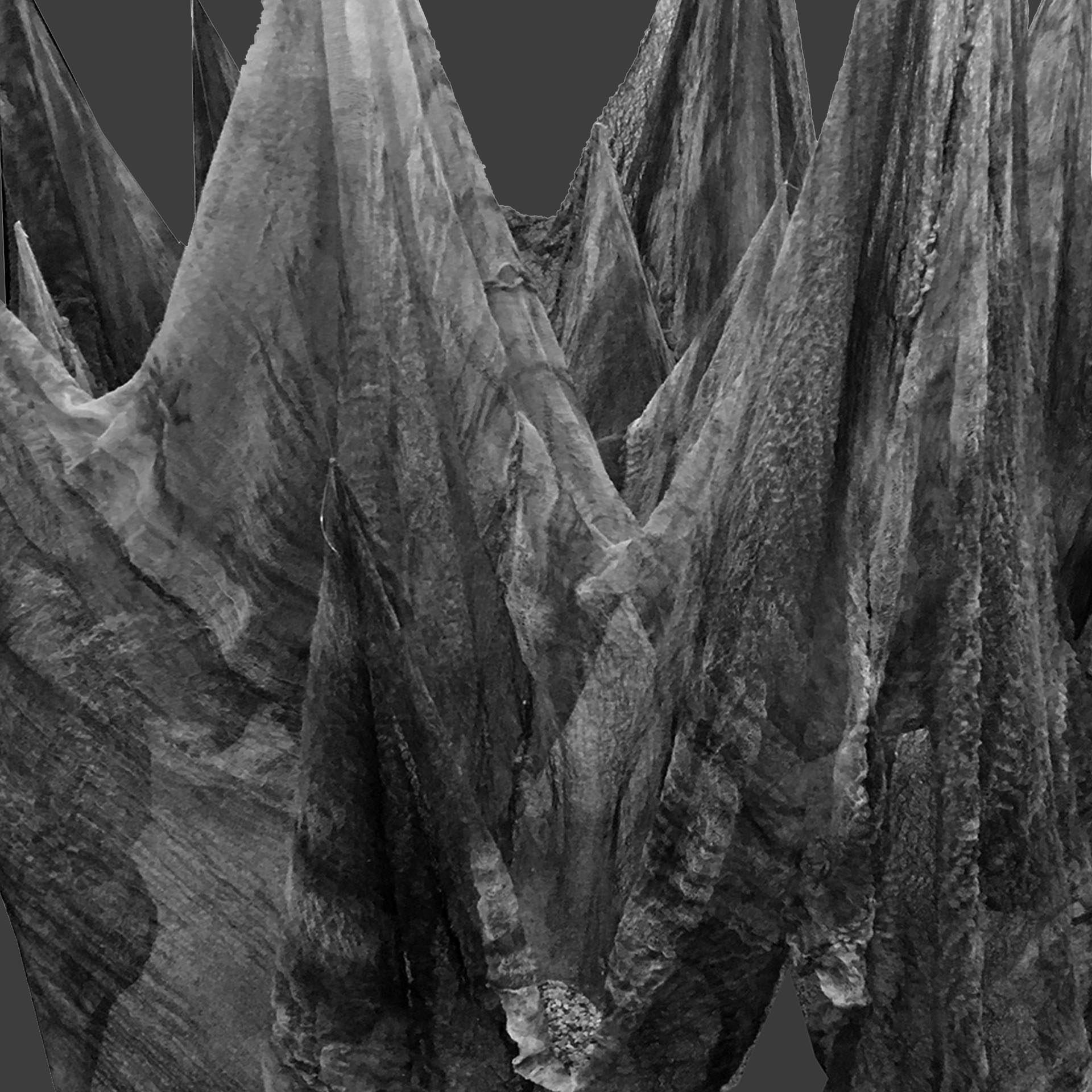 The image shows a black-and-white photograph of a thin cloth hanging from above. The fabric is gently pulled downward in several places by small, uneven pockets of sand, creating soft folds and shadows. The overall effect is quiet and somber, evoking a sense of weight and tension.