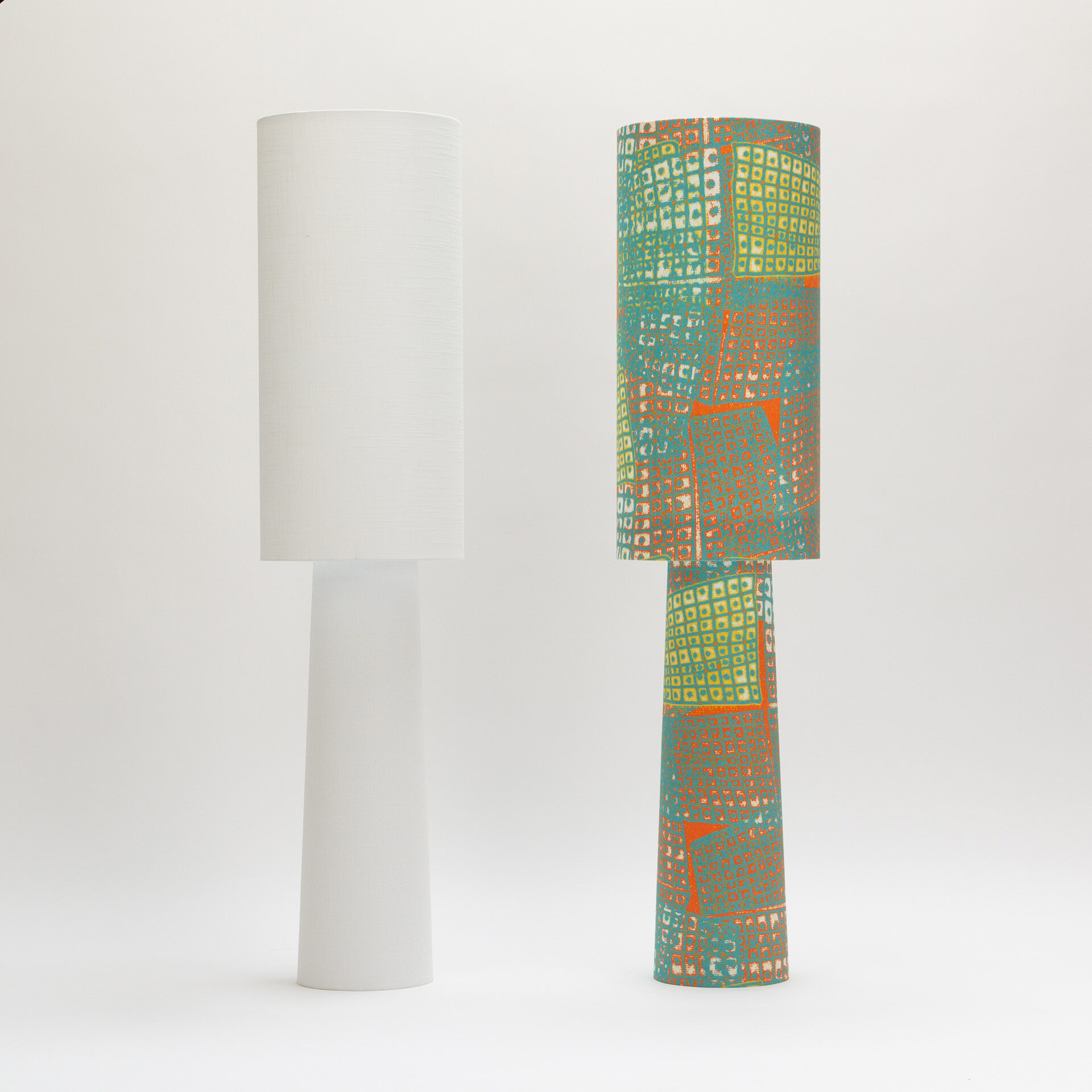 min/max floor lamp pair showing white minimalist version alongside turquoise and orange patterned version with geometric hand-drawn designs from the Ampli collection