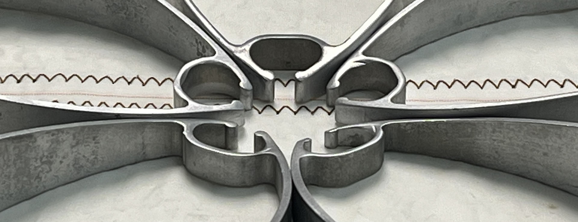 Close-up view of cut up sailboat mast sections arranged in a circular pattern placed on a sail.