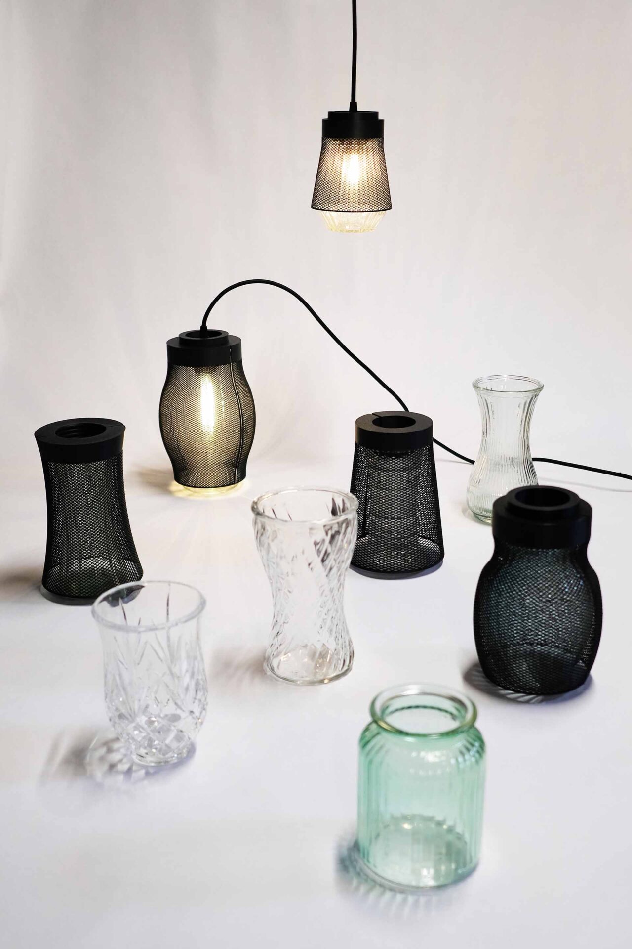 A display of vases and 3D-printed meshes that reveal the project’s lamp design exploration