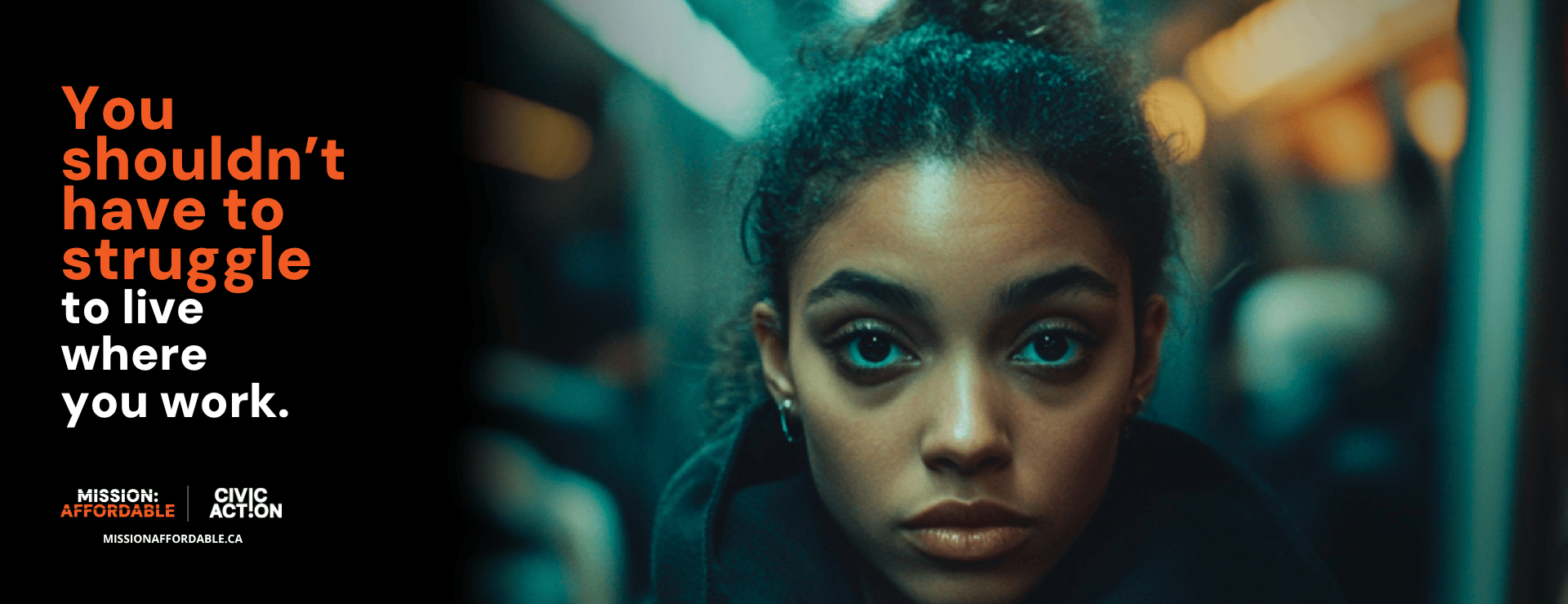A young woman with curly hair looks directly into the camera with a serious expression. She is seated on what appears to be a subway train, with blurred lights and passengers in the background. On the left side of the image, bold orange and white text reads:
“You shouldn’t have to struggle to live where you work". The overall tone is somber yet hopeful, highlighting the challenge of housing affordability for working people.