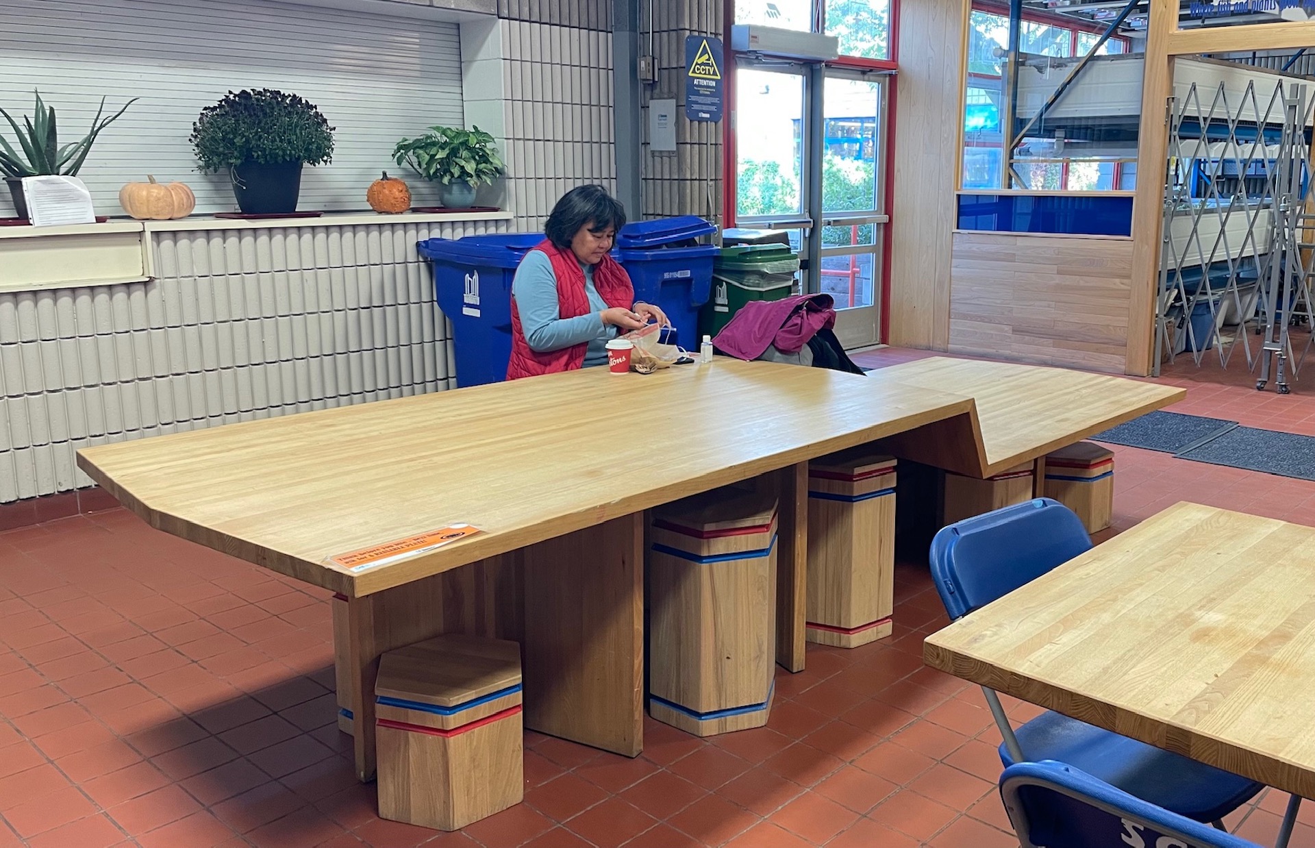 Community Dining Table, 2 levels surrounded by stools of various heights