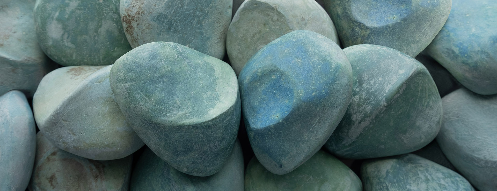 Hand-held sculptures in abstract forms with oxidized blue copper