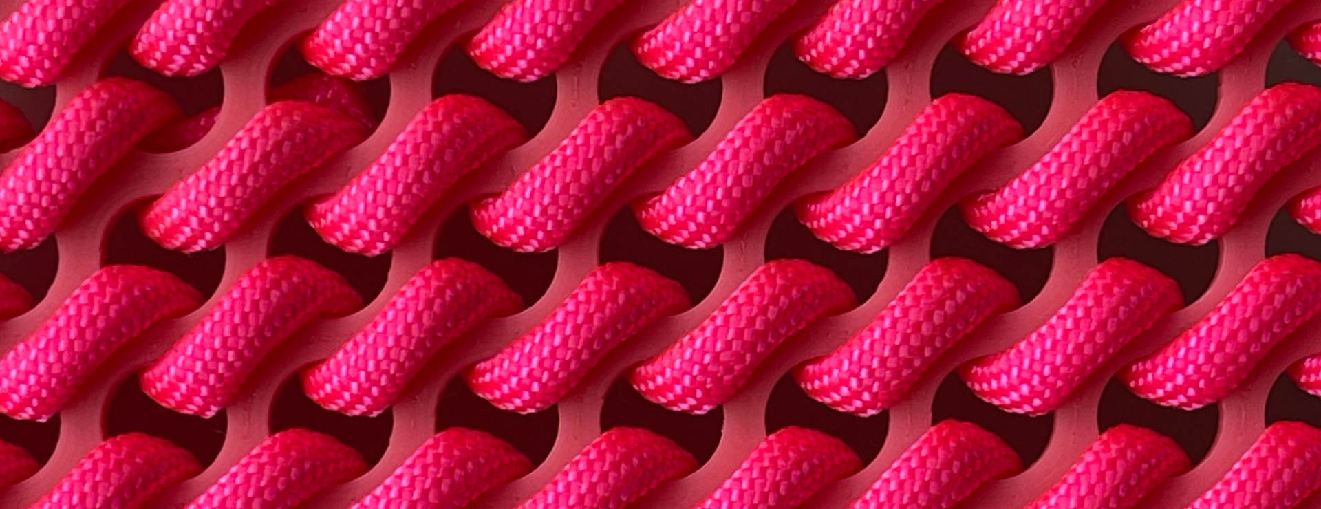 Detail image of pink rope embroidery on a custom plastic canvas