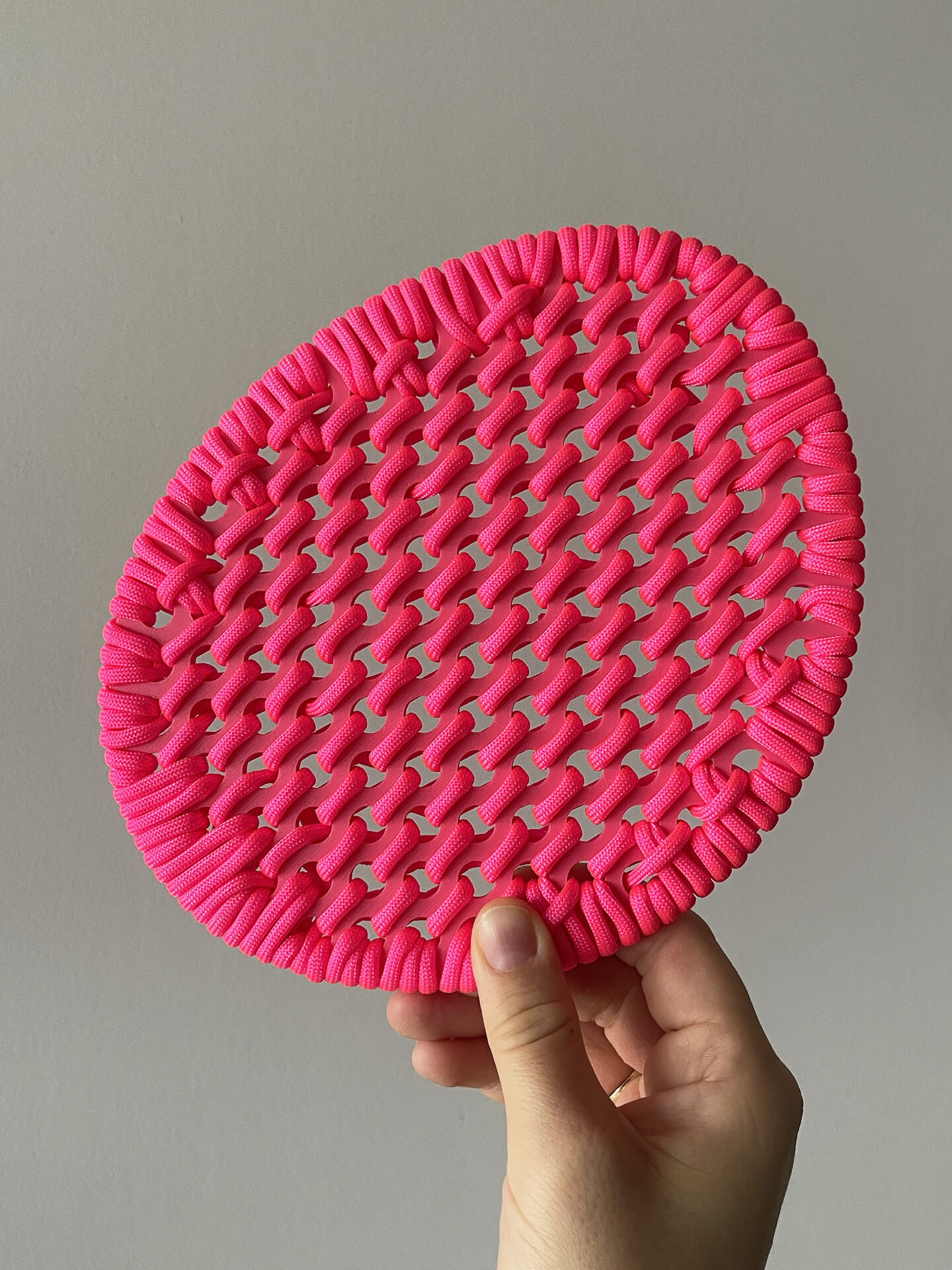Overall view of a pink dot shape embroidered with rope
