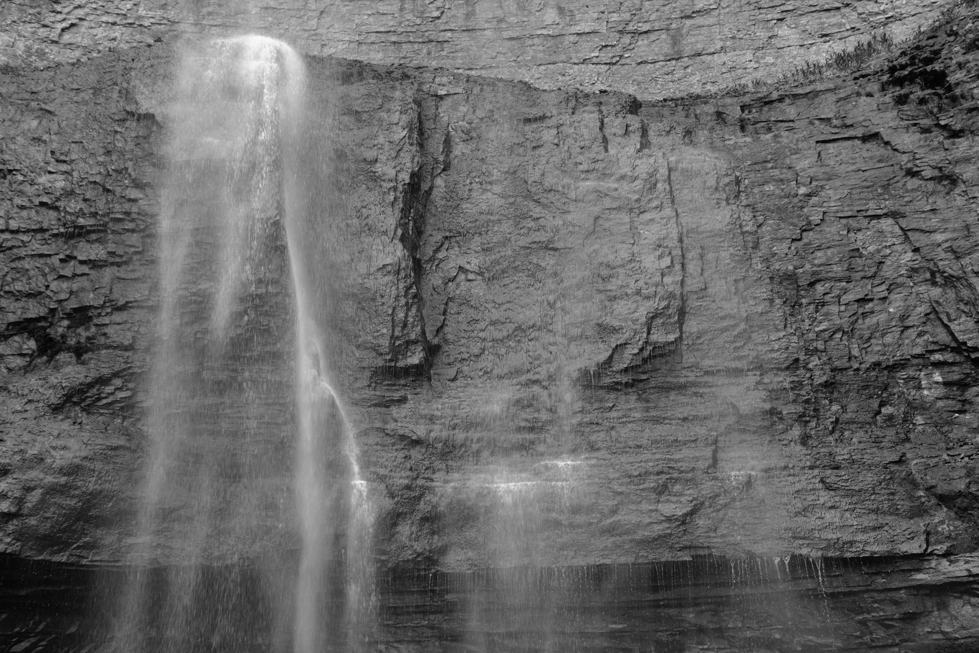 A black and white photograph of a waterfall on the Niagara Escarpment by artist Karen Miranda Abel.