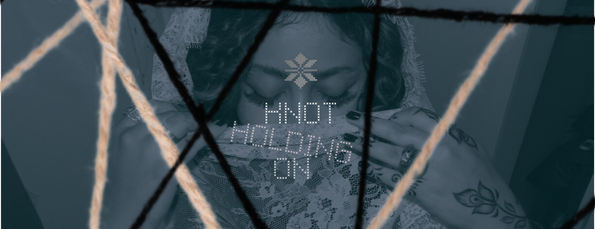 A banner design featuring the title “Knot: Holding On” in bold black text on a beige fabric background that resembles woven canvas. Below the title, in a handwritten black font, appears the artist’s name “noudiee.” and the phrase “to my identity” in smaller, thin black letters. Across the top and bottom edges, a repeating Tatreez (Palestinian embroidery) pattern decorates the banner — red at the top and green at the bottom — symbolizing Palestinian heritage.
