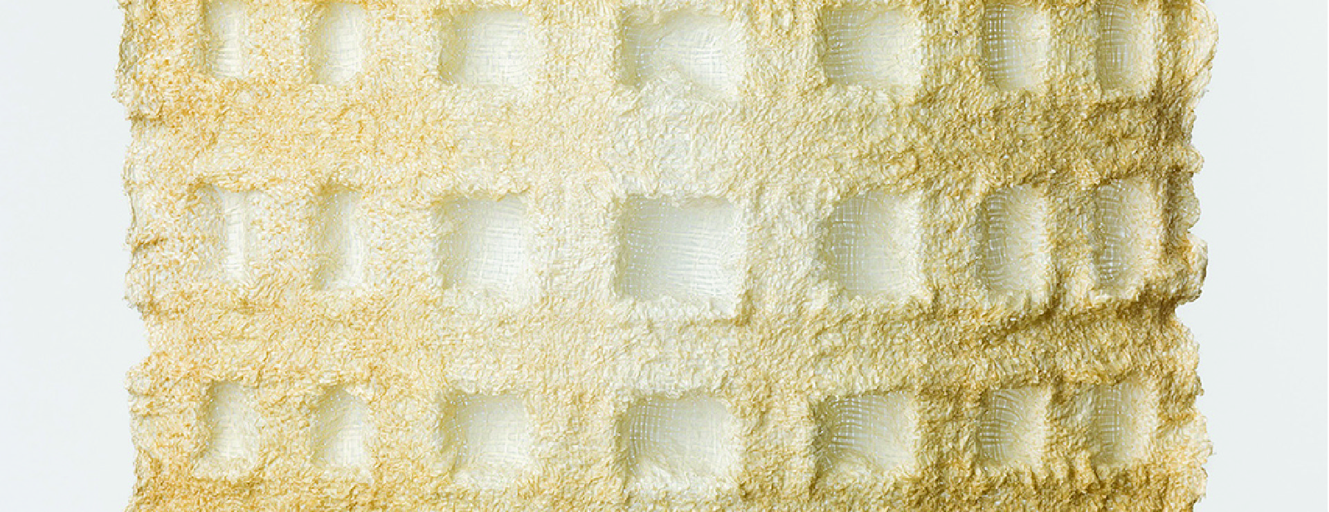 Translucent square mesh sheet with repeating vertical waves, cream-and-gray crosshatch lines, on white.