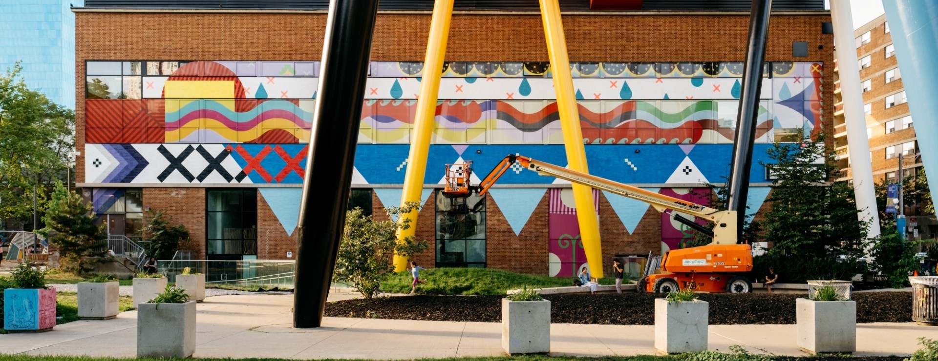 A photo of the large-scale colourful mural, pi'tawita'iek: we go up river, by Mi’kmaq visual artist Jordan Bennett.
