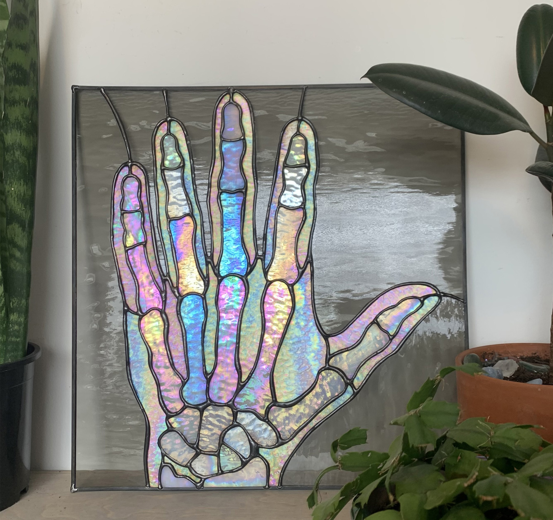 A stained glass portrait of a hand xray.