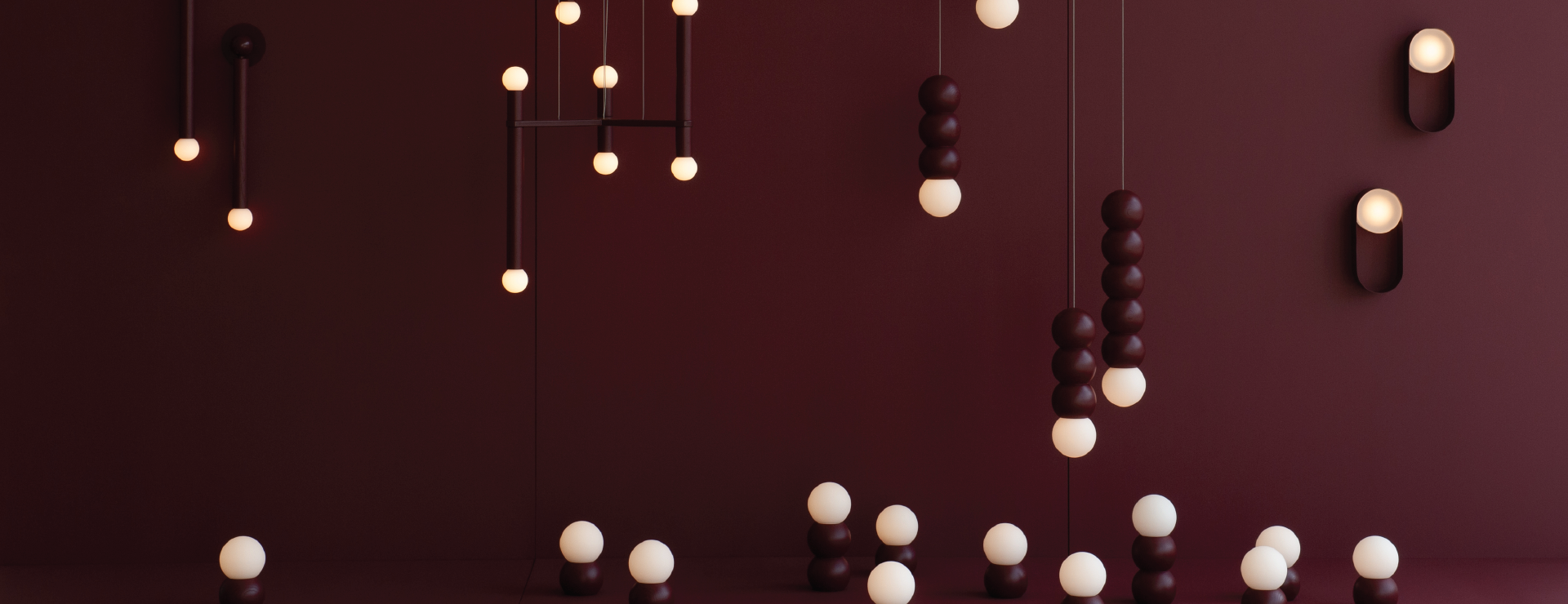An array of wall-mounted, ceiling-mounted and grounded light fixtures, with circular characteristics in a dark burgundy