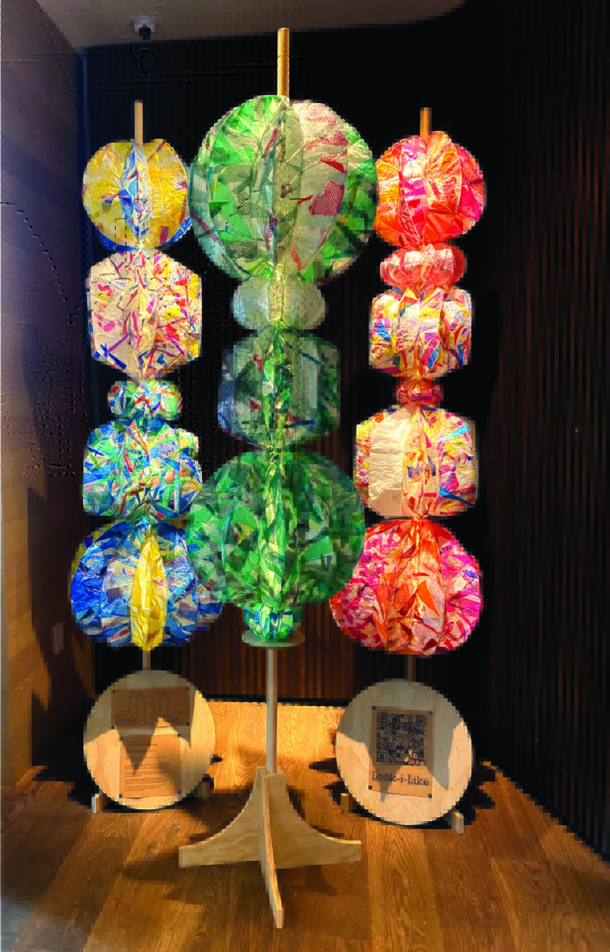 Full image of Sculptures in an abandoned pool. Three, 8 ft. sculptures. Each sculpture made of multiple Plastic balls on a wooden central pole.