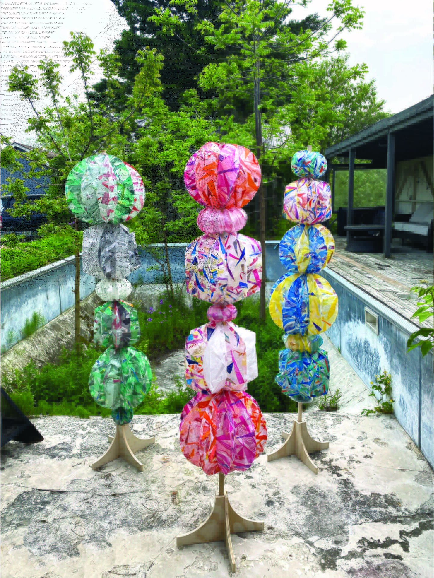 Full image of Sculptures in an abandoned pool. Three, 8 ft. sculptures. Each sculpture made of multiple Plastic balls on a wooden central pole.