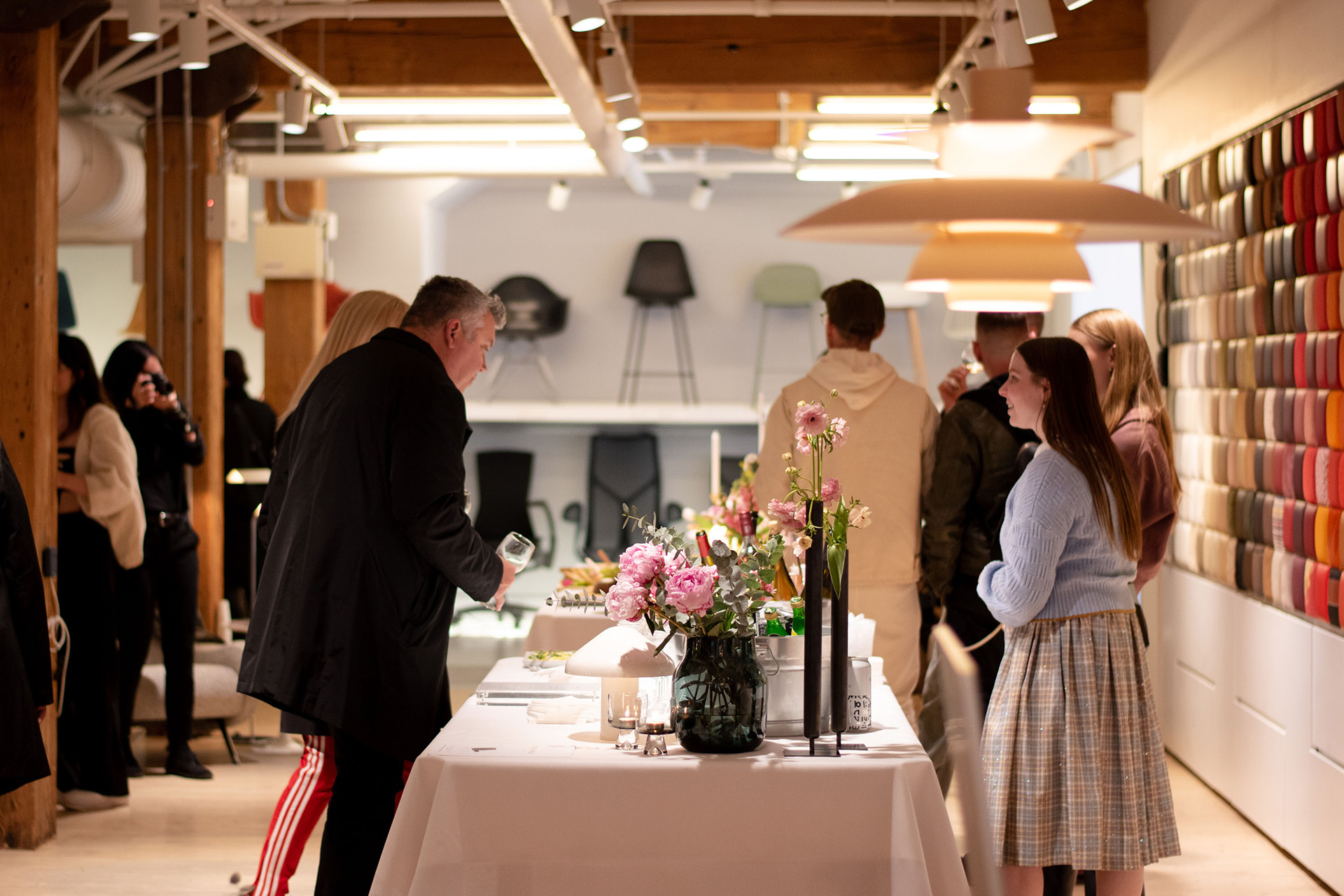 People considering and selecting bites in the Design Within Reach Toronto showroom.