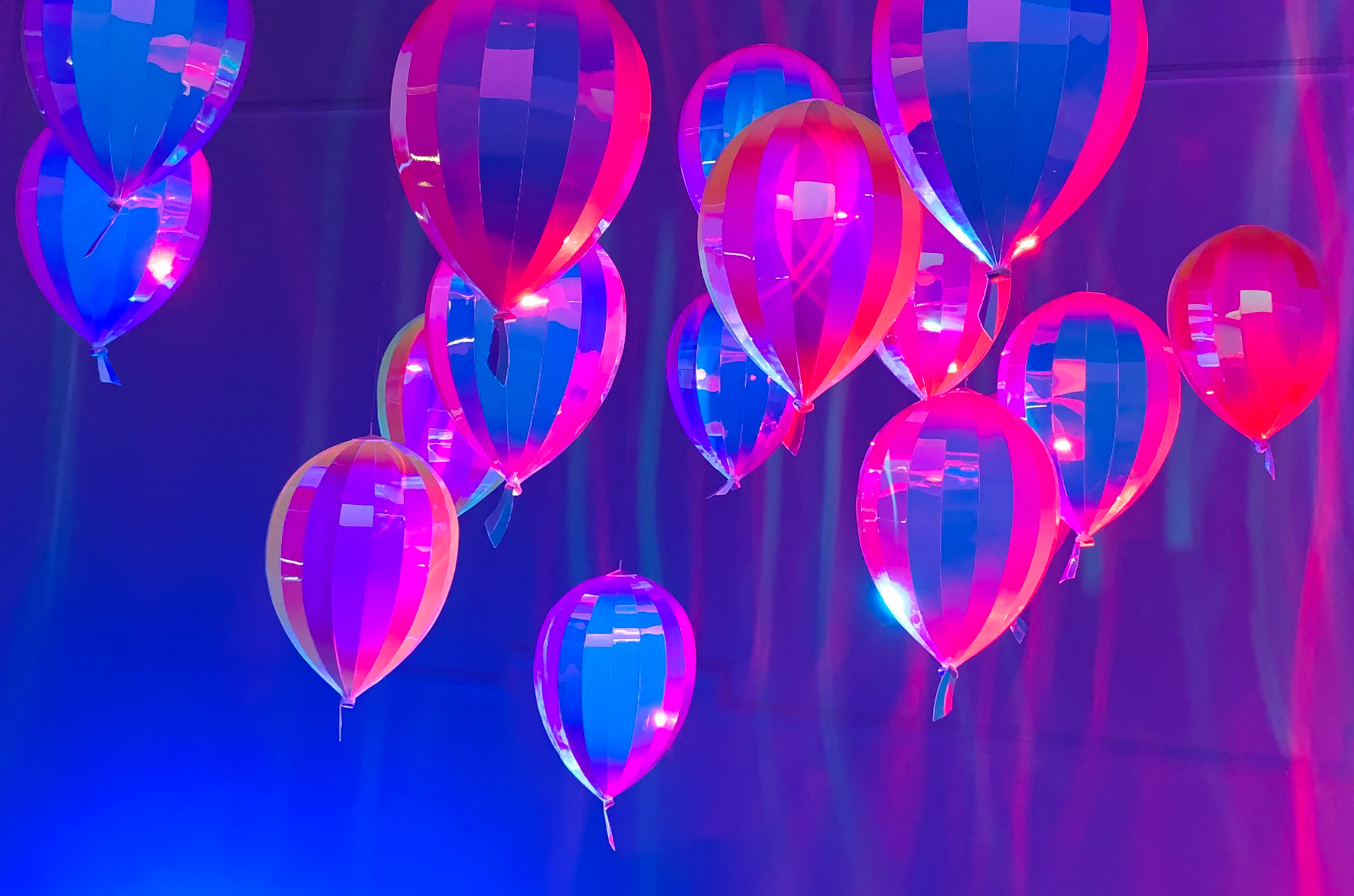 Sculptural metallic party balloons that bounce a myriad of colors throughout the space