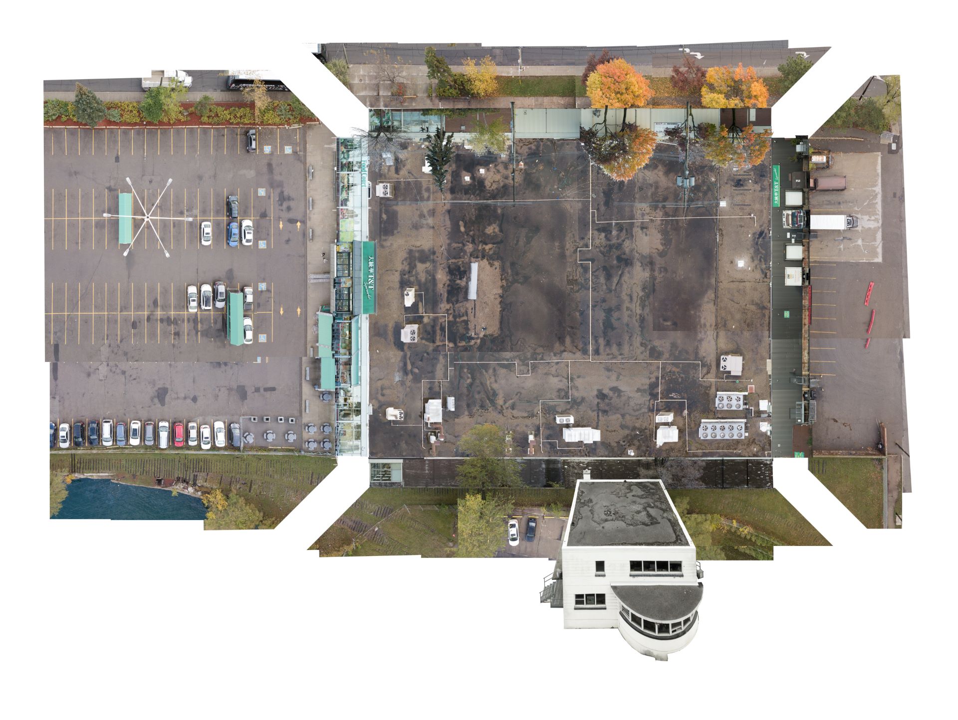 Aerial view of parking lot and buildings composed of multiple photographs.