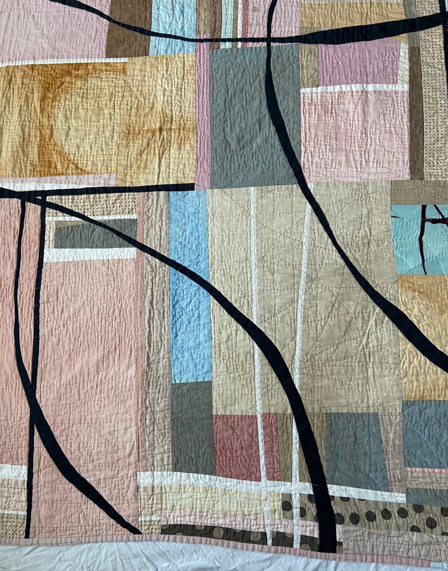 Fabric pieces hand-stitched in an organic pattern