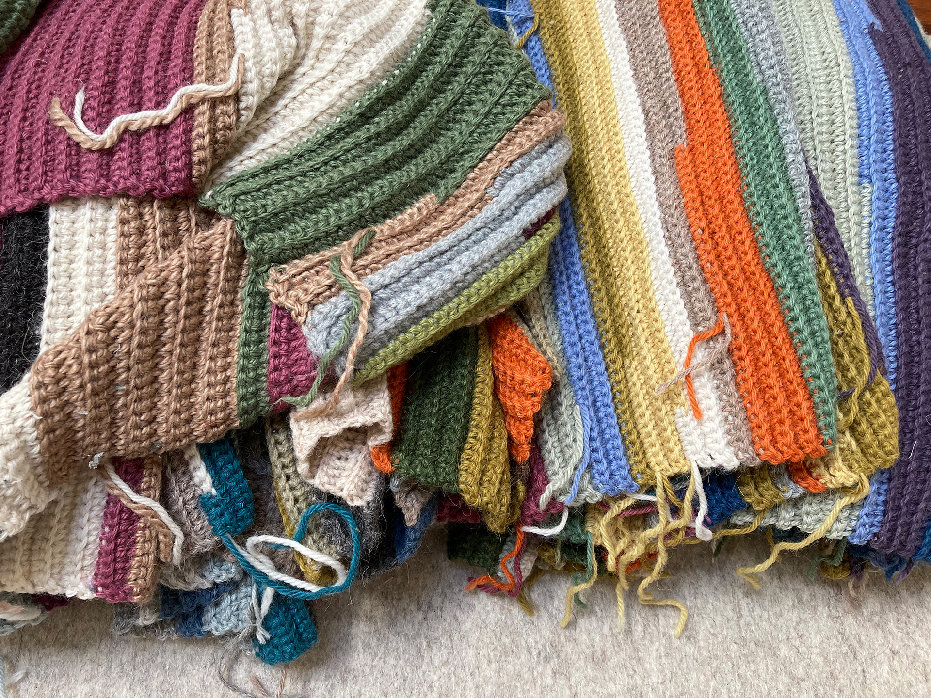 Continuos rows of crochet yarn in different colours.