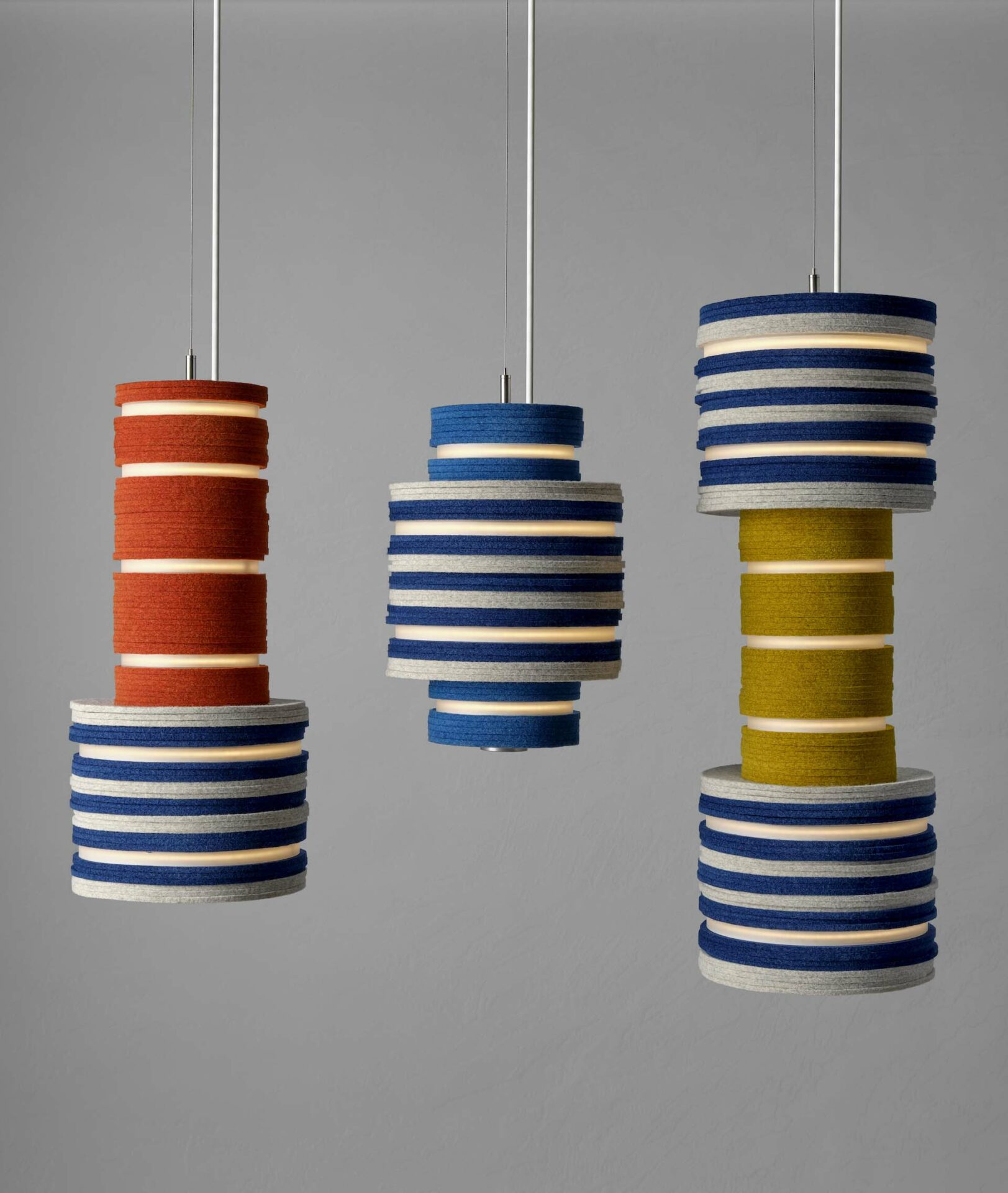 3 pendant lights made from circles of felt blue, grey, orange and yellow