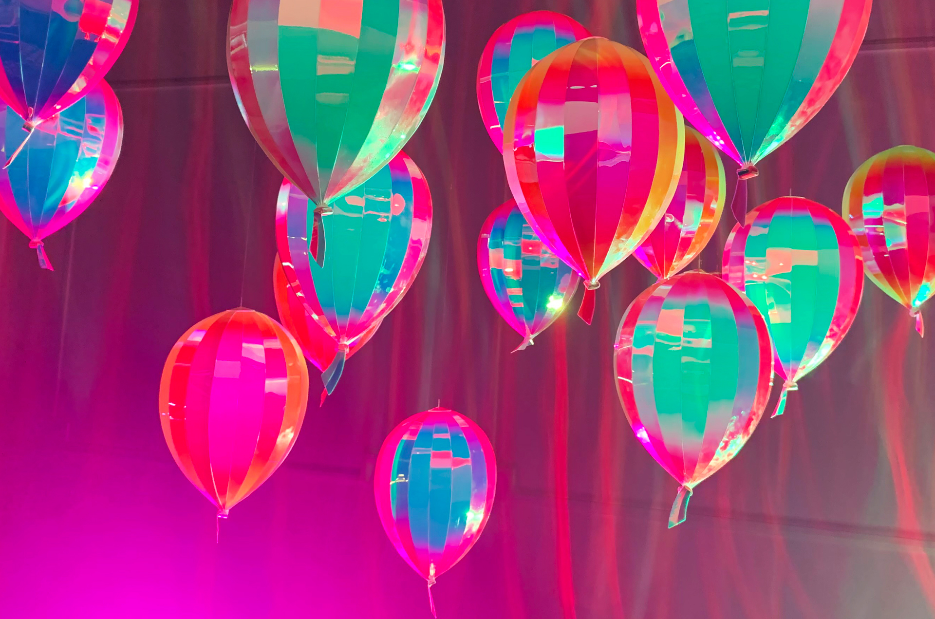 Sculptural metallic party balloons that bounce a myriad of colors throughout the space