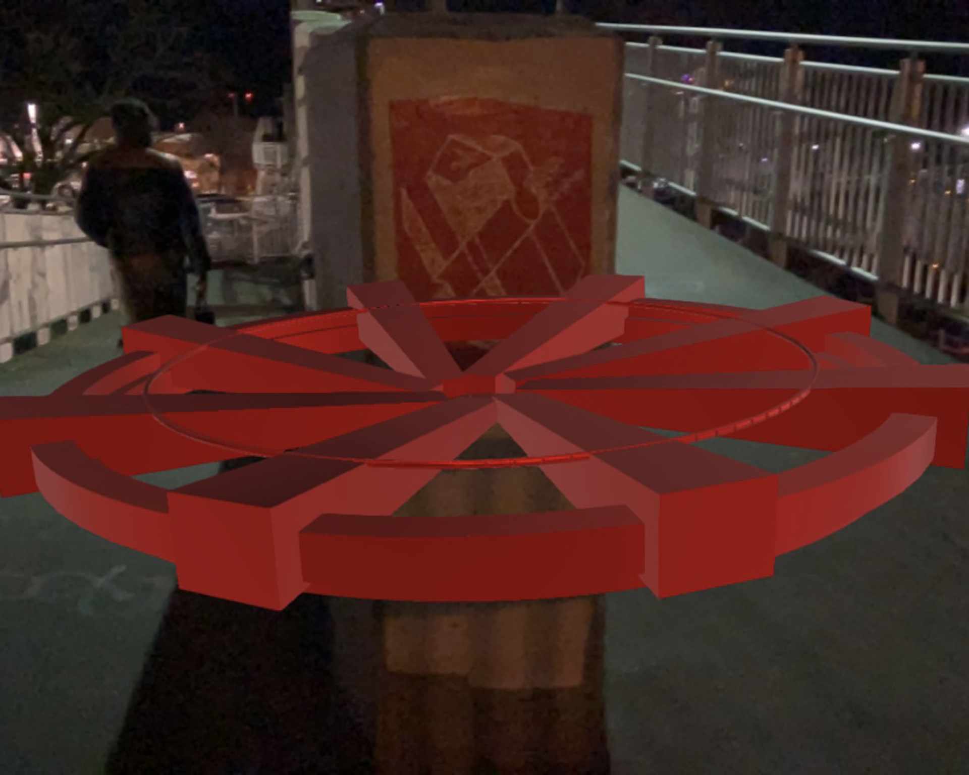 red wheel fountain AR model at night against the footbridge and figures back