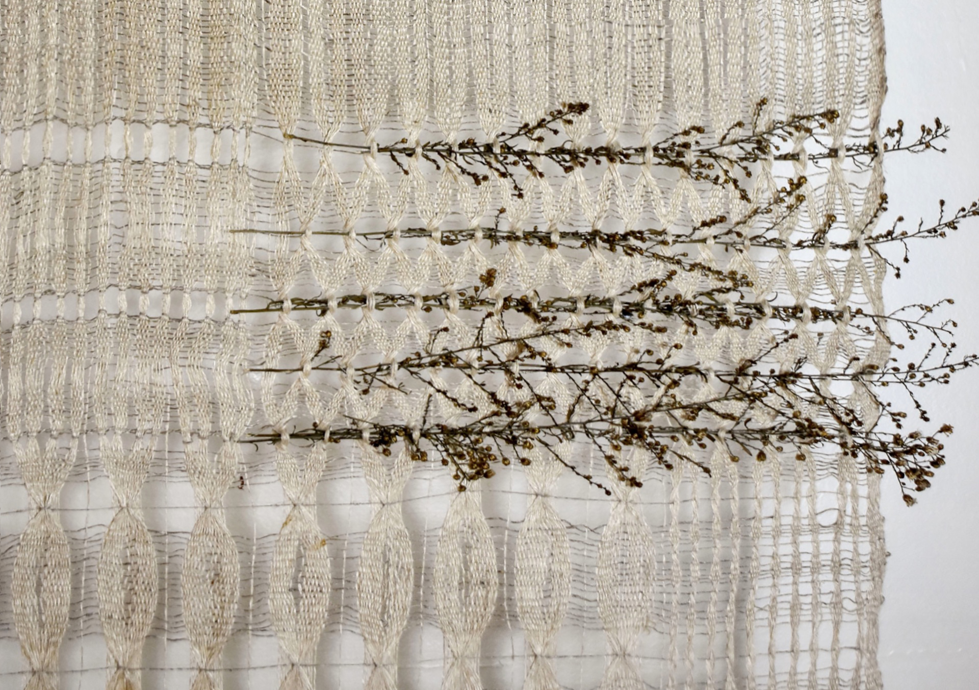 Open weave hemp/paper textile with embedded grasses