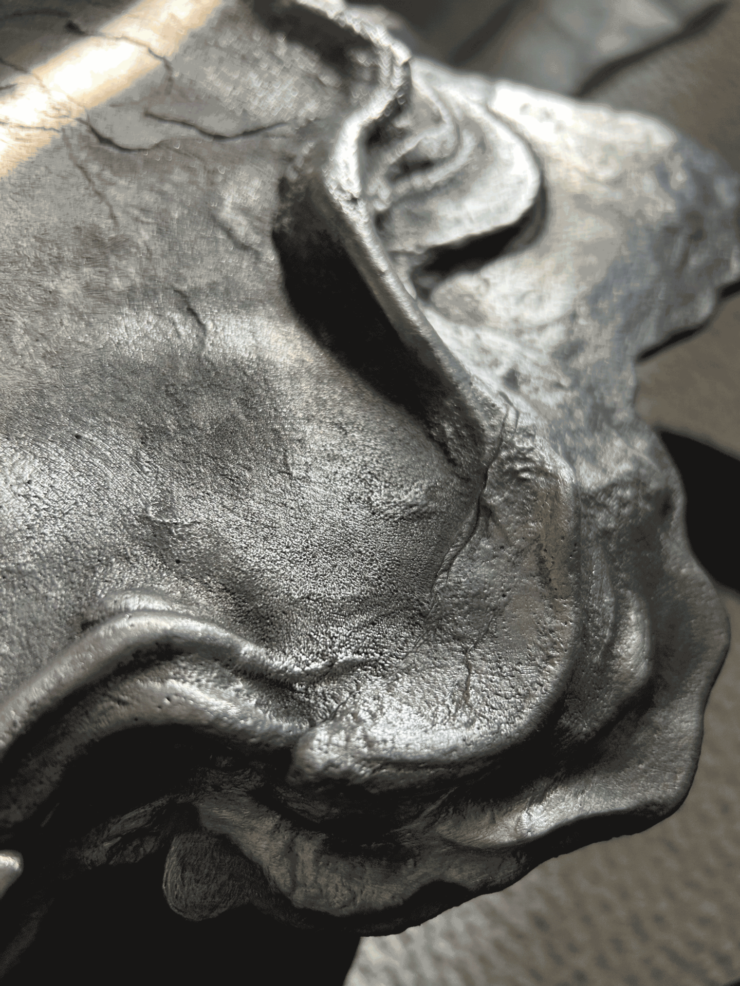 Closeup of organic sculptural piece made of sand cast aluminum