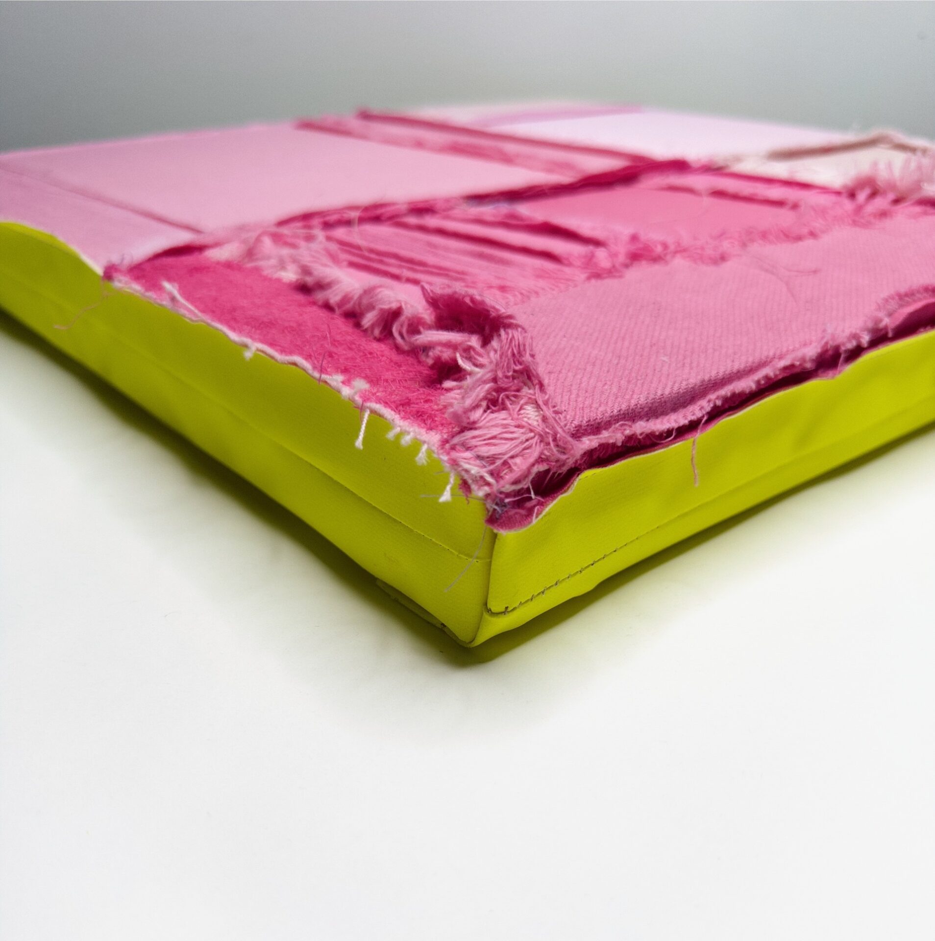 Pink fabric stretched on a board