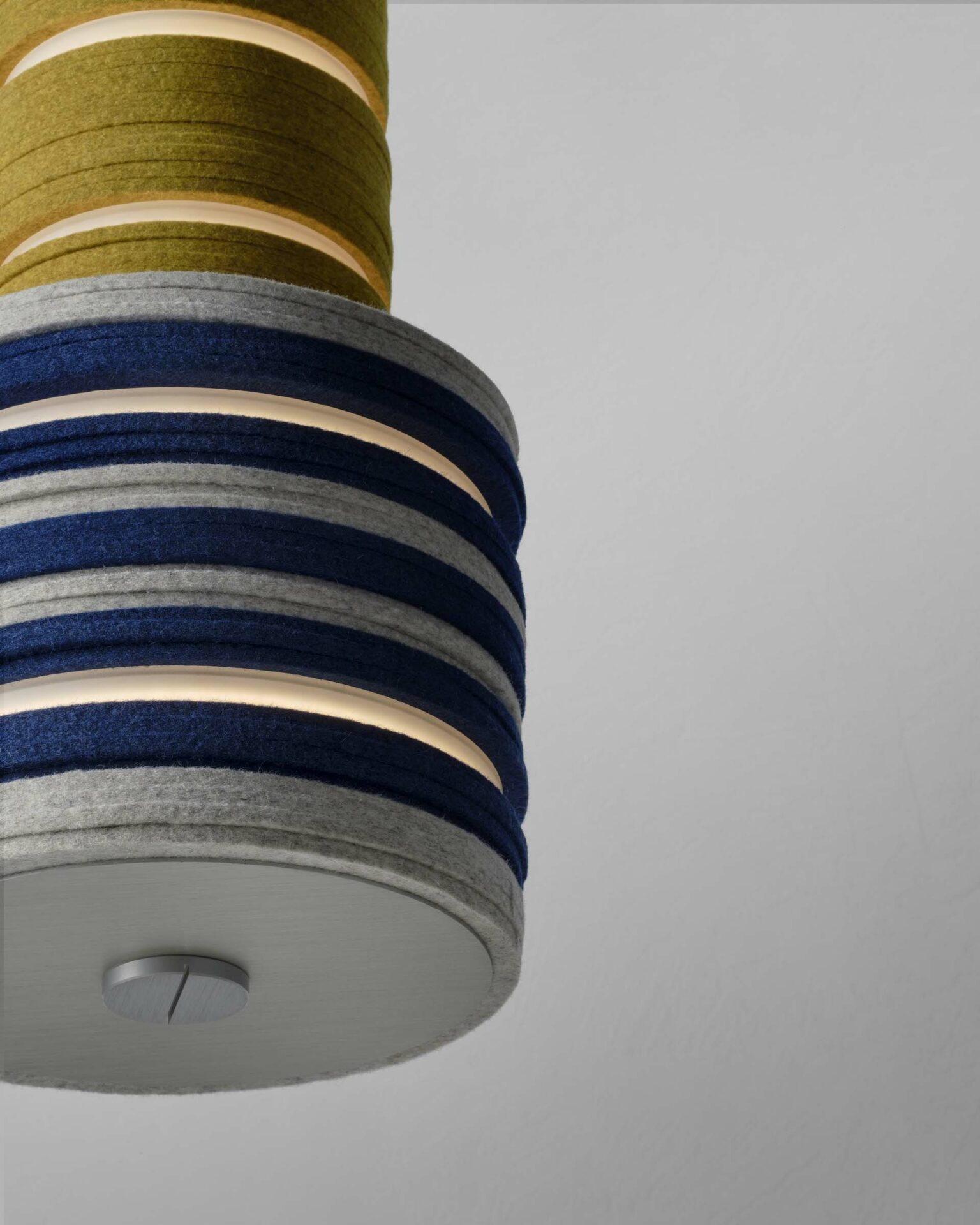 Close up of a pendant light made from circles of felt in blue, grey and yellow