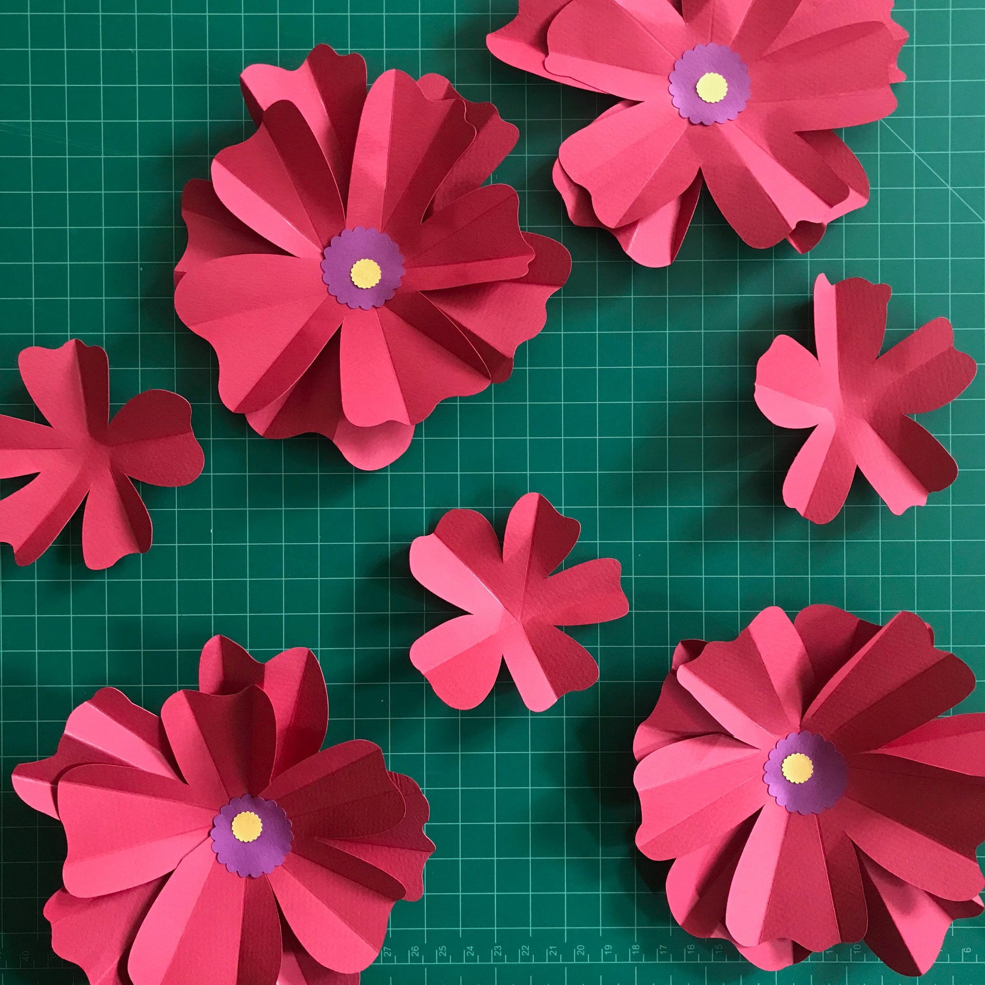 paper poppies being assembled on a work surface