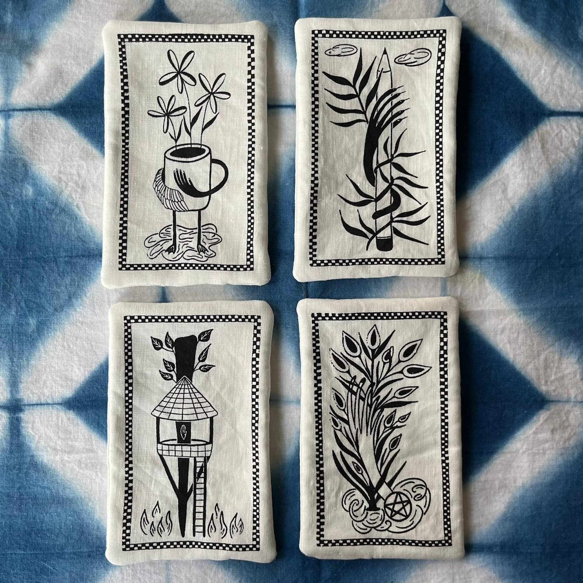 Fabric printed with black images of tarot card illustrations